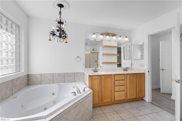 bathroom with a chandelier, tile patterned floors, vanity, and independent shower and bath