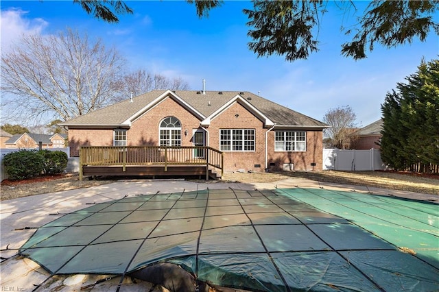 back of property with a pool side deck and a patio area