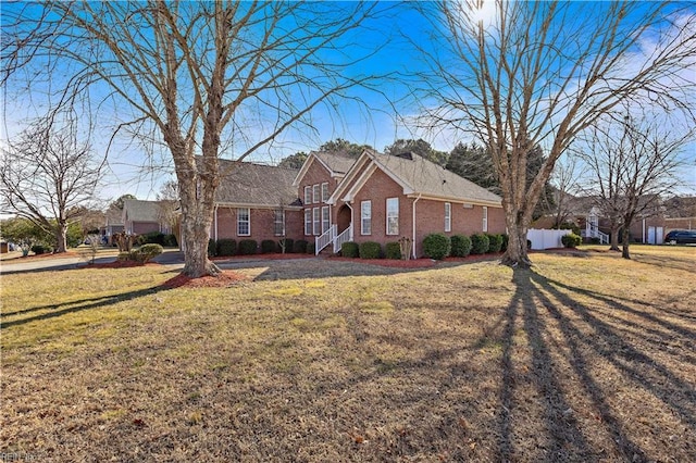 ranch-style home with a front lawn