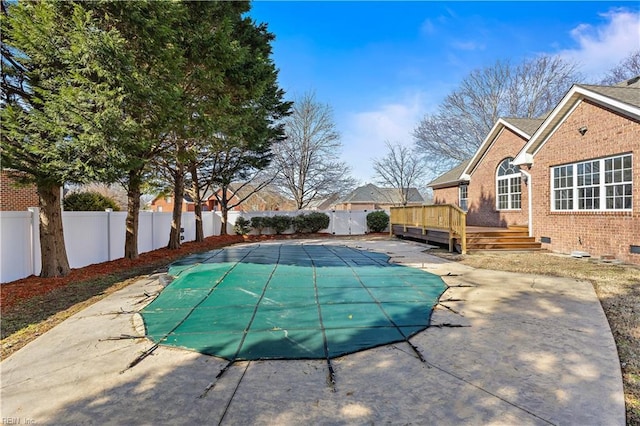 view of pool featuring a deck and a patio area