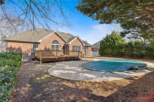 back of house featuring a pool side deck and a patio