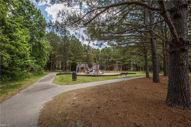 view of home's community with a playground and a lawn