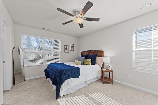 bedroom featuring light colored carpet and ceiling fan