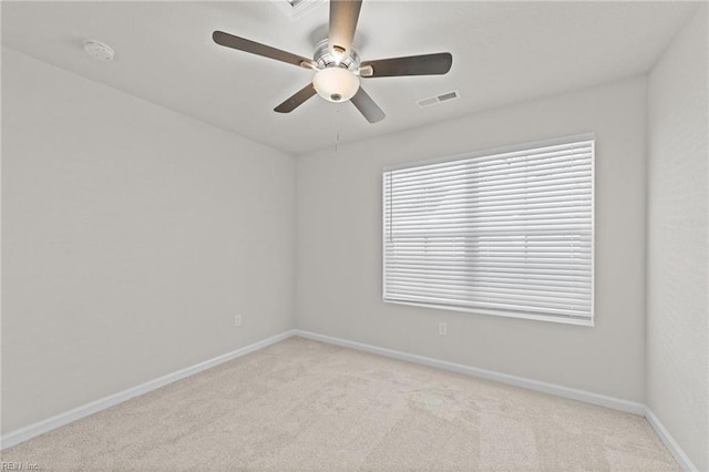 spare room with light carpet and ceiling fan