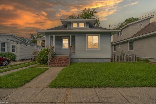 view of front of property featuring a porch and a lawn