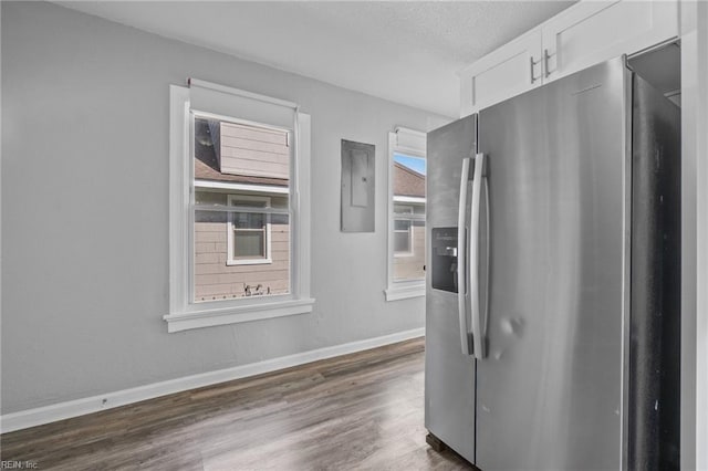 kitchen featuring white cabinetry, dark hardwood / wood-style flooring, electric panel, and stainless steel refrigerator with ice dispenser