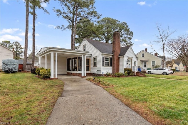 bungalow-style home with a front lawn and a carport