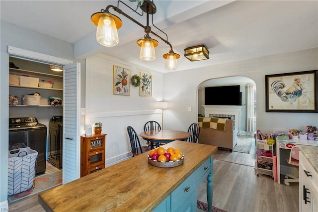 dining room with wood-type flooring and washer and clothes dryer