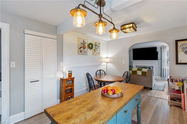 dining space with beamed ceiling and light hardwood / wood-style floors