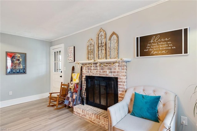 sitting room featuring ornamental molding, hardwood / wood-style floors, and a fireplace