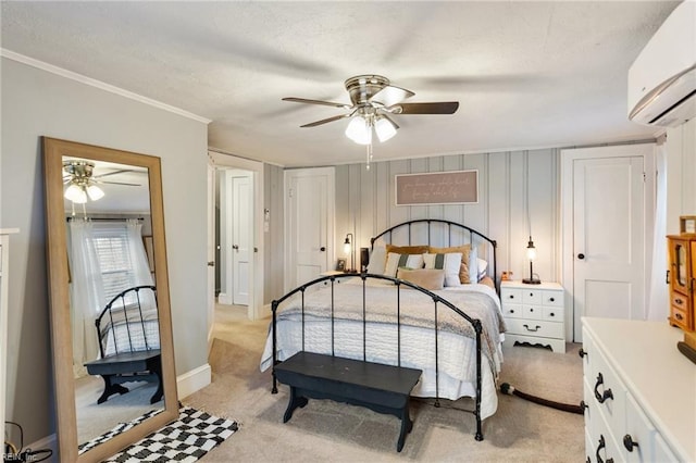 bedroom with ceiling fan, crown molding, light colored carpet, and a wall unit AC