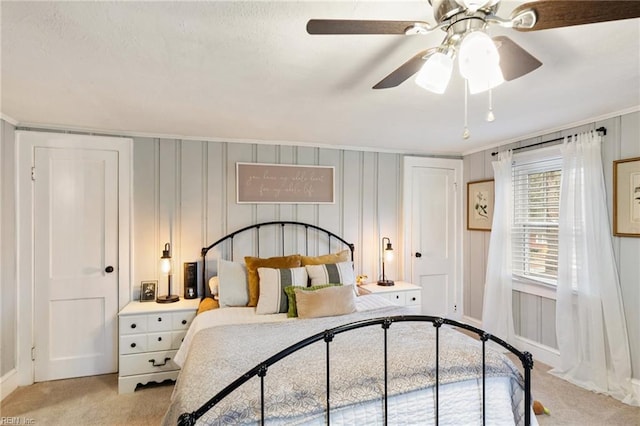 bedroom featuring light carpet, ornamental molding, and ceiling fan