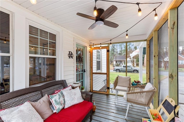 sunroom / solarium featuring ceiling fan