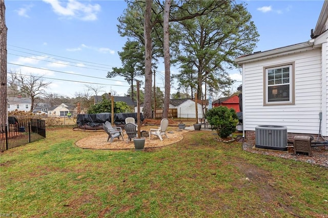 view of yard featuring central AC unit and a fire pit