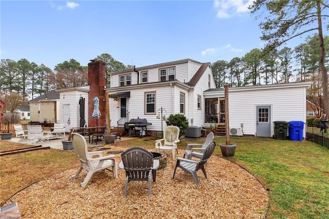 back of house featuring an outdoor fire pit, a yard, central AC unit, and a patio area