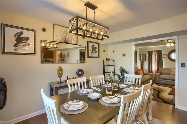 dining area featuring ceiling fan and dark hardwood / wood-style flooring