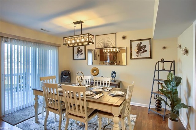 dining space with dark hardwood / wood-style flooring