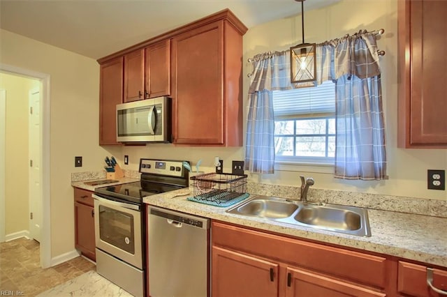 kitchen featuring pendant lighting, sink, and stainless steel appliances