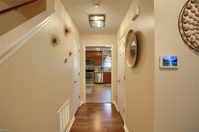 hall with dark wood-type flooring