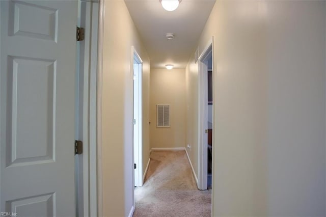 hall with light colored carpet