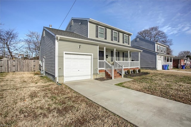 view of front of house with a garage, a front yard, and a porch