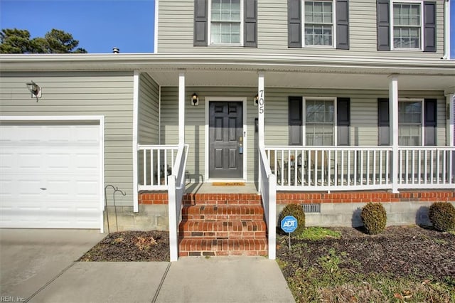 entrance to property featuring a garage and covered porch