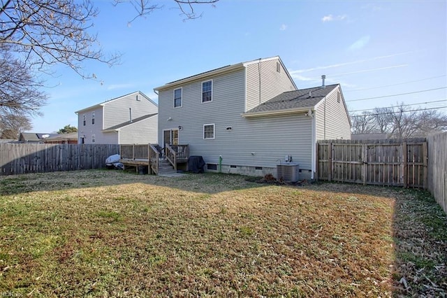 back of house with a wooden deck, cooling unit, and a lawn