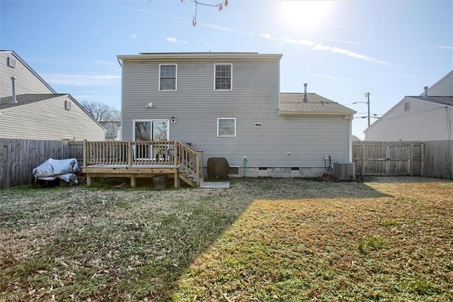 rear view of property featuring a deck, a lawn, and central air condition unit