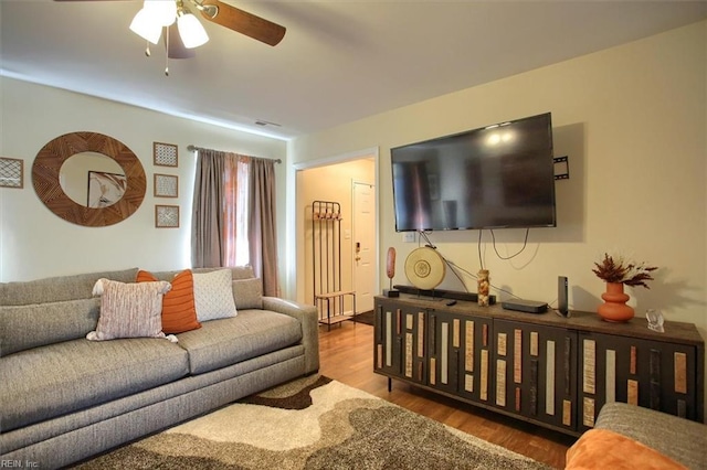 living room featuring hardwood / wood-style floors and ceiling fan