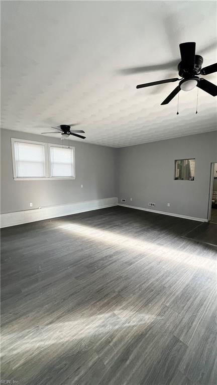 empty room featuring ceiling fan and dark hardwood / wood-style floors