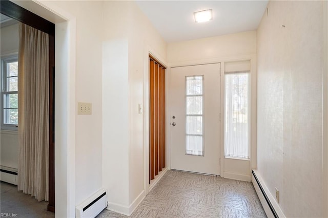 doorway with light parquet floors and baseboard heating