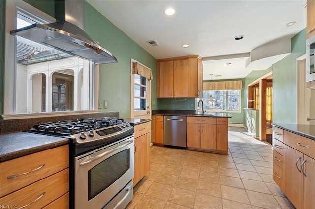 kitchen with light tile patterned flooring, appliances with stainless steel finishes, sink, and exhaust hood