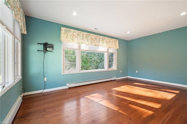 unfurnished room featuring a baseboard radiator and wood-type flooring