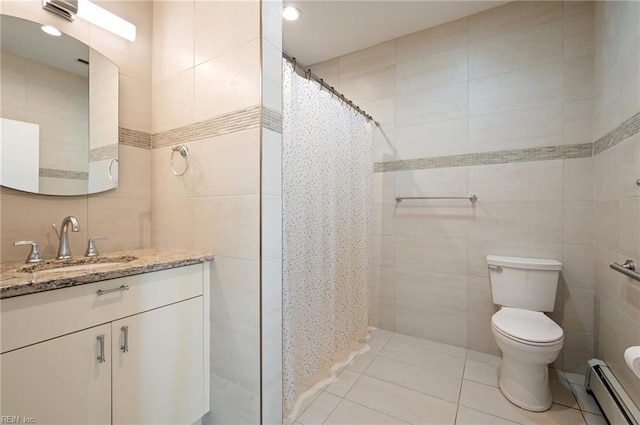 bathroom featuring tile patterned floors, toilet, tile walls, vanity, and a baseboard heating unit