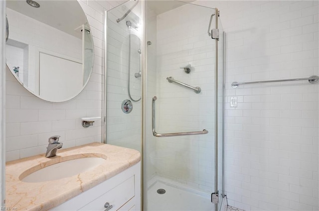 bathroom with vanity and a shower with shower door