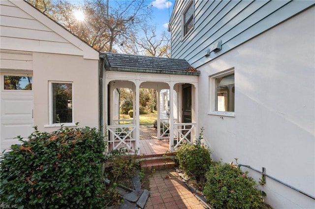 view of exterior entry with a garage