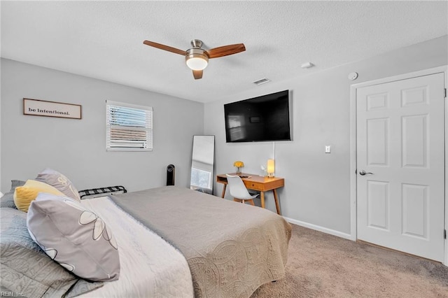 bedroom featuring light carpet, a textured ceiling, and ceiling fan