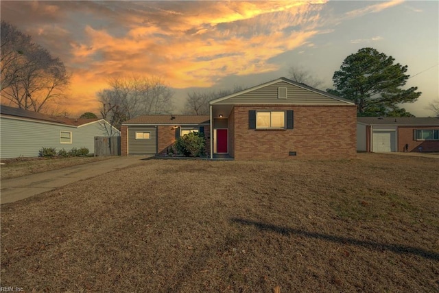 ranch-style house featuring a lawn