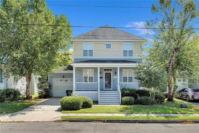 traditional style home with a porch, a garage, driveway, roof with shingles, and a front yard