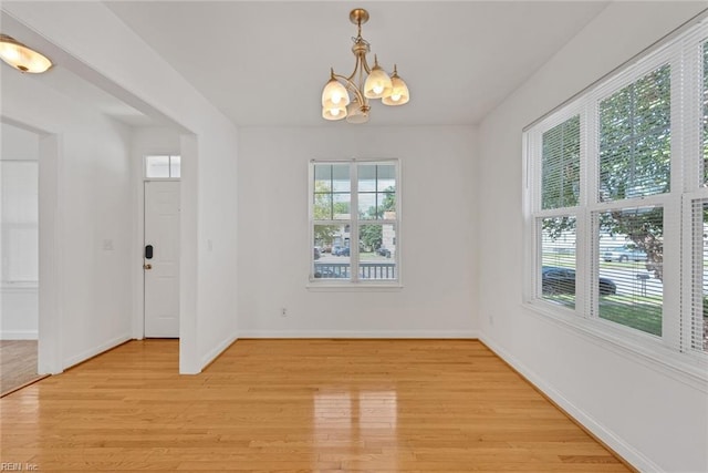 interior space with an inviting chandelier and light hardwood / wood-style floors