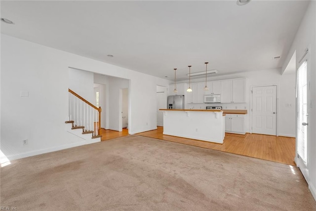 unfurnished living room featuring light carpet