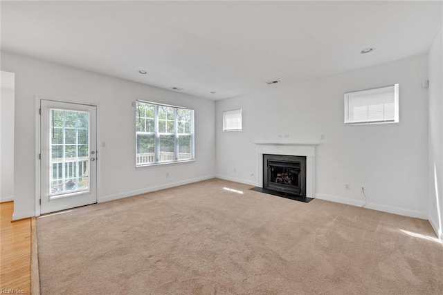 unfurnished living room featuring light colored carpet