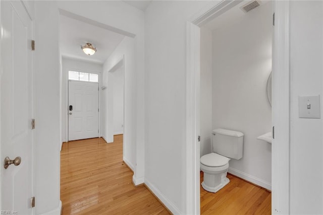 bathroom with wood-type flooring and toilet