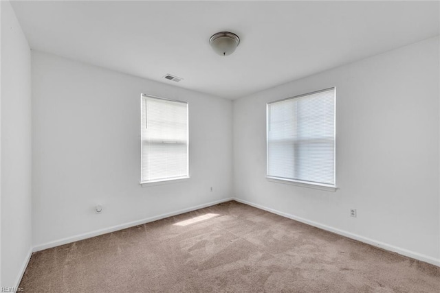 empty room with light colored carpet