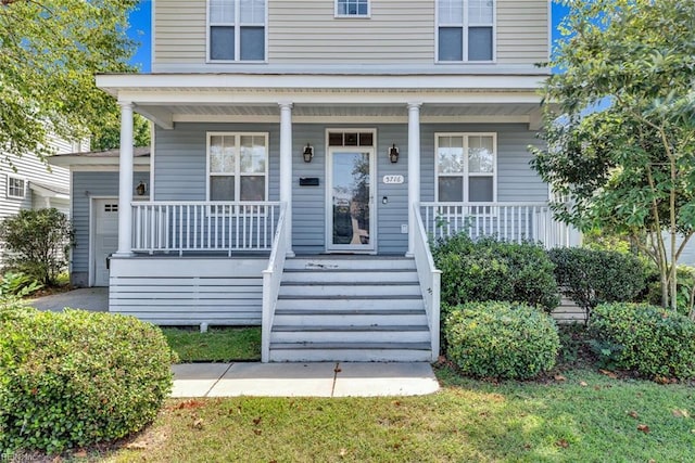 view of exterior entry featuring a porch