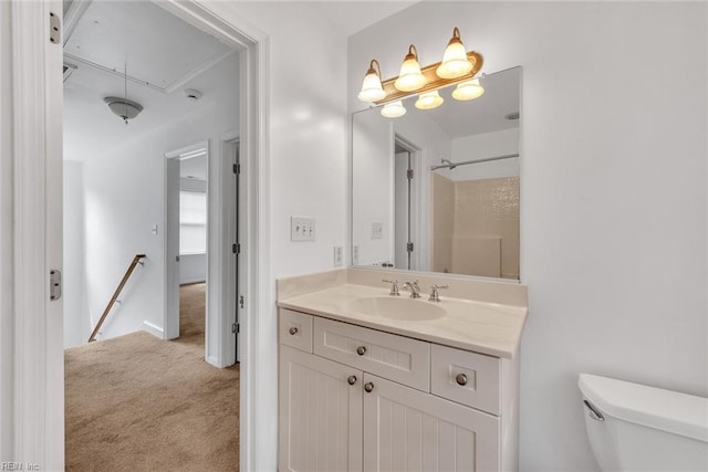 bathroom with walk in shower, vanity, and toilet