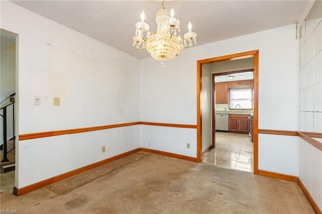 carpeted spare room with sink and a notable chandelier