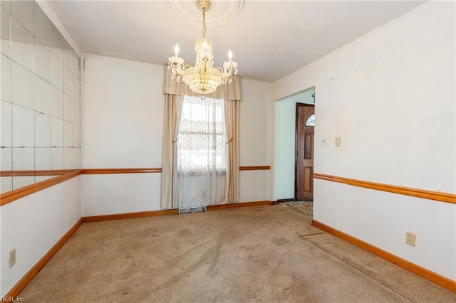 unfurnished room with a chandelier and light carpet