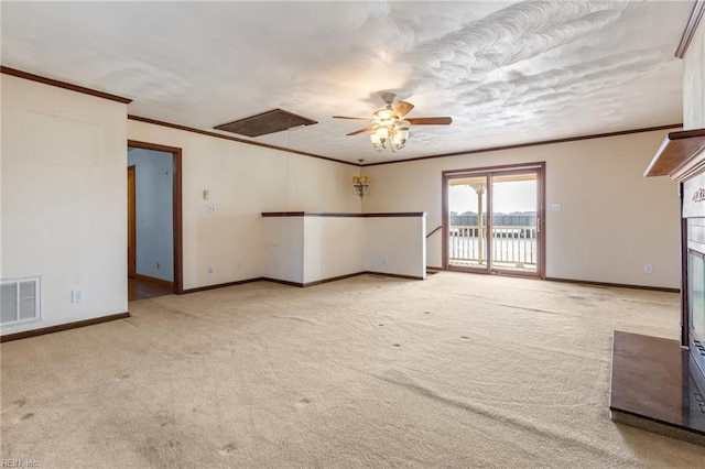 carpeted empty room with crown molding and ceiling fan