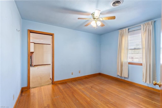 spare room featuring ceiling fan and light hardwood / wood-style floors